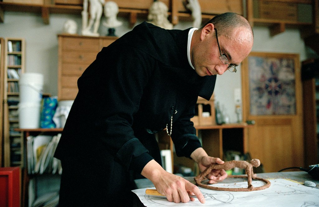 Guest Father Jean-Sébastien is working on a crucifix that he has designed.